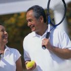 If Tennis is your “Racquet" Florida is your Place Smiling Couple on Tennis Court