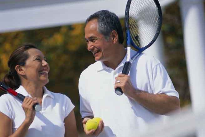 Smiling Couple on Tennis Court