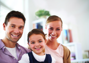 Ease the Transition of Moving With Kids - iStock 000039046232Large web Portrait of a happy young family at home