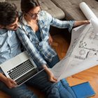 How NOT to Design Your New Home Young couple examining blueprints of they new house.Moving house